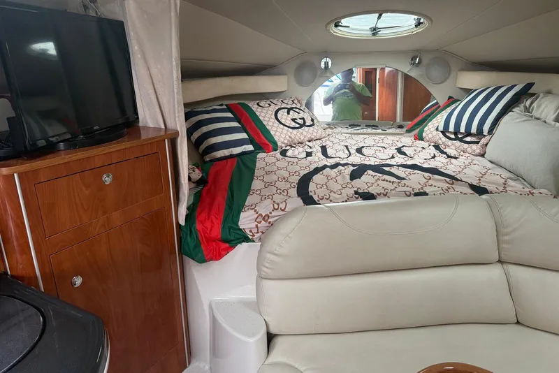 Slide: The Image of Luxurious 2007 Doral Intrigue cabin interior with Gucci bedding and wooden cabinetry. - 17