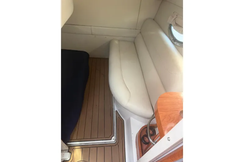 Slide: The Image of 2007 Doral Intrigue cabin interior with white leather seating and wooden flooring. - 20