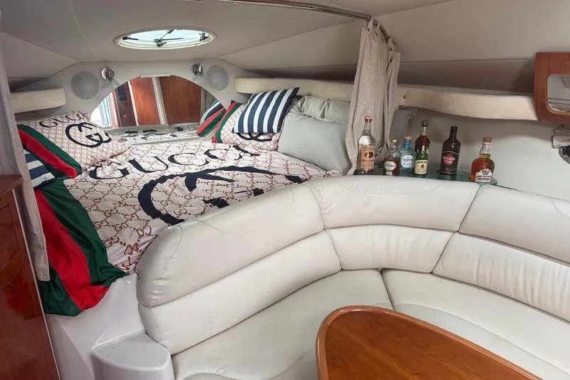 Slide: The Image of 2007 Doral Intrigue cabin interior with luxury bedding and assorted liquor bottles. - 24