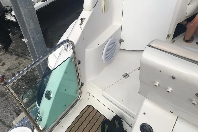 Slide: The Image of 2007 Doral Intrigue boat interior with white seating and glass door. - 25