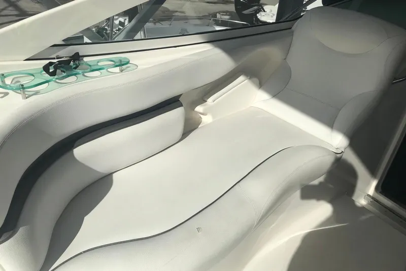 Slide: The Image of 2007 Doral Intrigue boat interior with white seating and cup holders. - 28