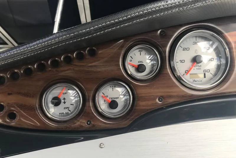Slide: The Image of Dashboard of a 2007 Doral Intrigue boat with gauges for oil, RPM, and temperature. - 29