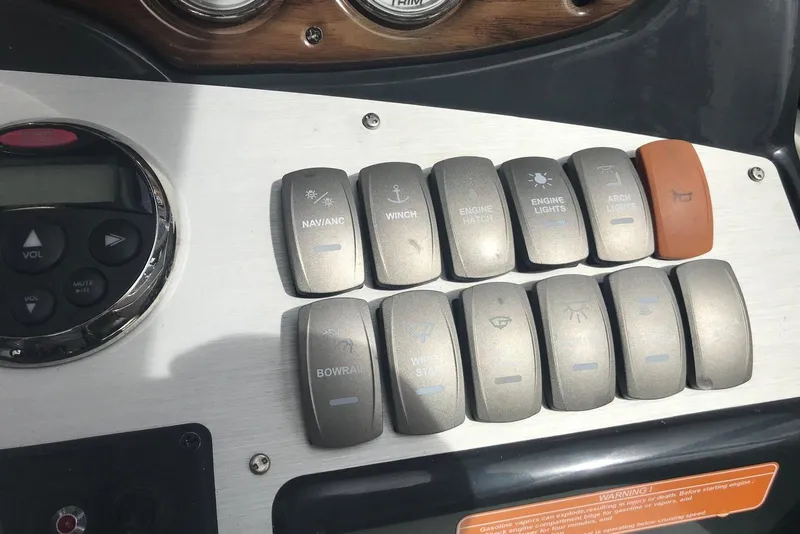 Slide: The Image of Control panel of a 2007 Doral Intrigue boat with labeled switches and buttons. - 31
