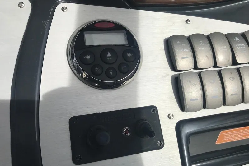 Slide: The Image of Control panel of a 2007 Doral Intrigue boat with buttons and display. - 32