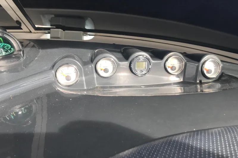 Slide: The Image of Dashboard of a 2007 Doral Intrigue boat with gauges and compass. - 33