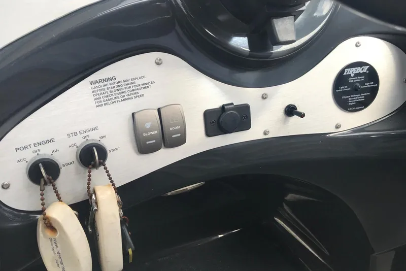 Slide: The Image of Control panel of a 2007 Doral Intrigue boat with engine switches and warning labels. - 34