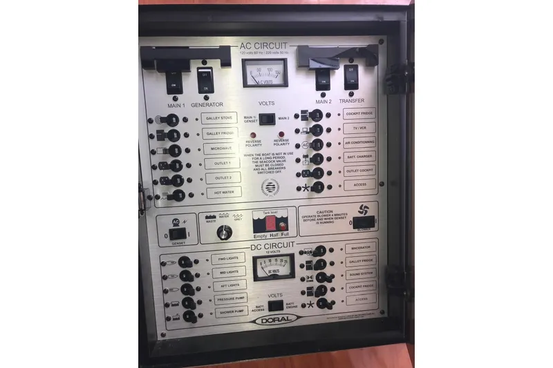 Slide: The Image of Electrical control panel of a 2007 Doral Intrigue boat, featuring AC and DC circuits. - 35