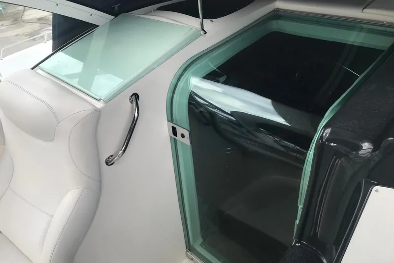 Slide: The Image of 2007 Doral Intrigue boat interior with white seating and glass hatch. - 36