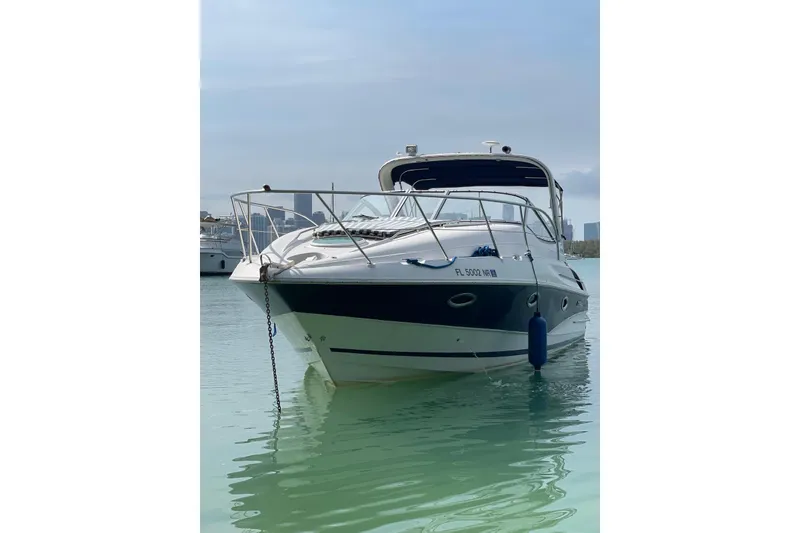 Slide: The Image of 2007 Doral Intrigue boat on calm water, front view with city skyline background. - 4