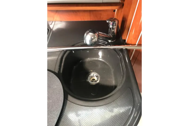 Slide: The Image of 2007 Doral Intrigue boat kitchen sink with chrome faucet and wooden cabinetry. - 41