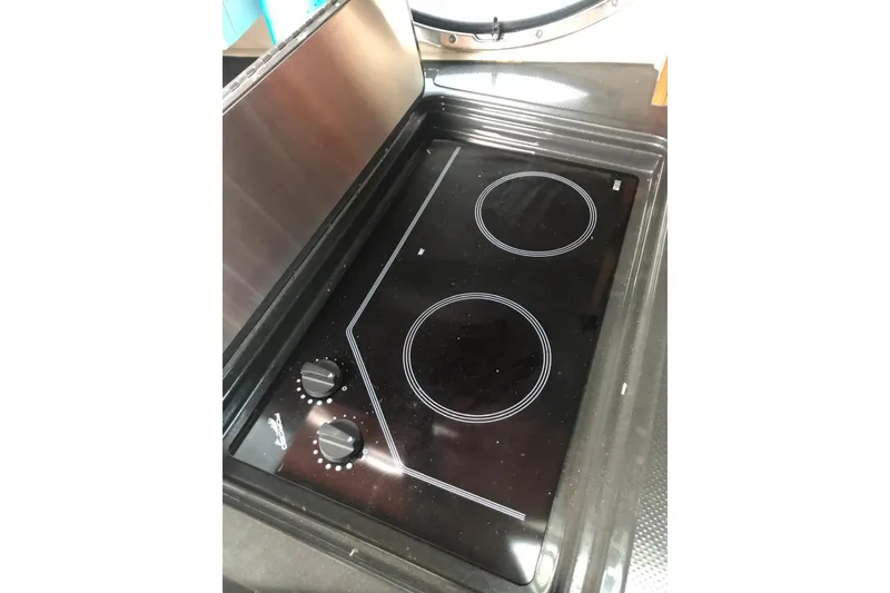 Slide: The Image of Glass cooktop with two burners in a 2007 Doral Intrigue boat kitchen. - 42