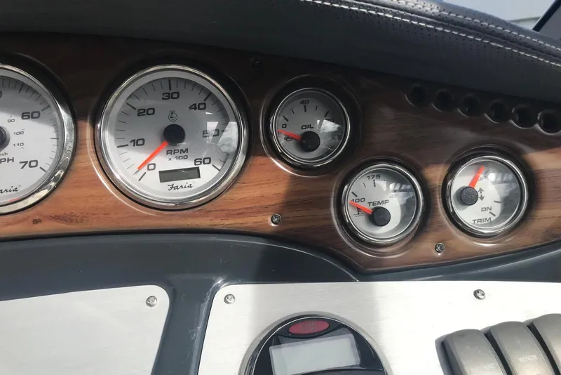 Slide: The Image of Dashboard of a 2007 Doral Intrigue boat with RPM, oil, temperature, and trim gauges. - 46