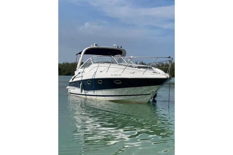 Slide: The Image of 2007 Doral Intrigue boat anchored on calm water under a clear sky. - 5