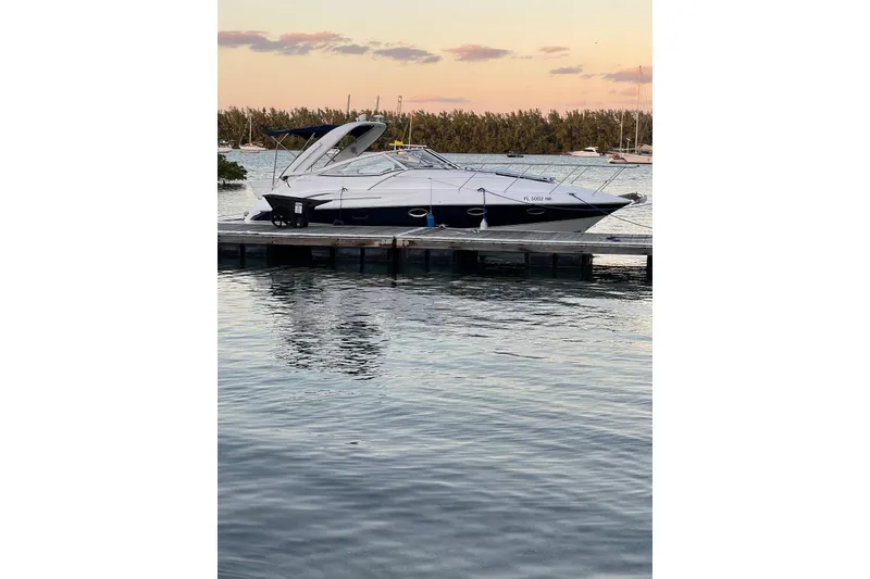 Slide: The Image of 2007 Doral Intrigue boat docked at sunset, calm water reflecting the vessel. - 7