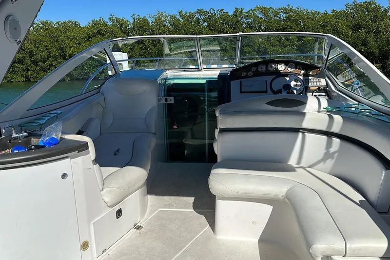 Slide: The Image of 2007 Doral Intrigue boat interior with white seating and control panel. - 9