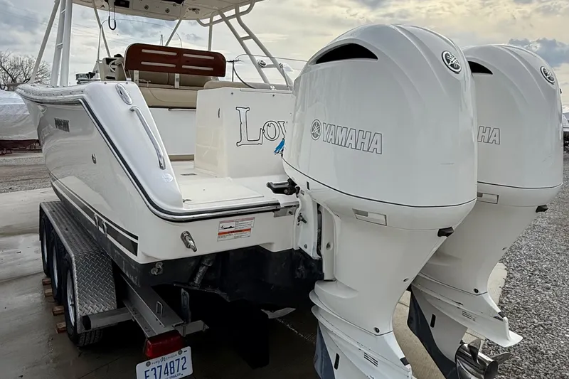 Slide: The Image of 2016 Pursuit S 280 Sport boat with dual Yamaha outboard engines on a trailer. - 10