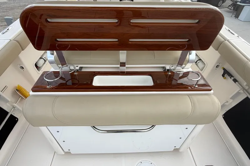 Slide: The Image of 2016 Pursuit S 280 Sport boat interior with wooden accents and cup holders. - 13