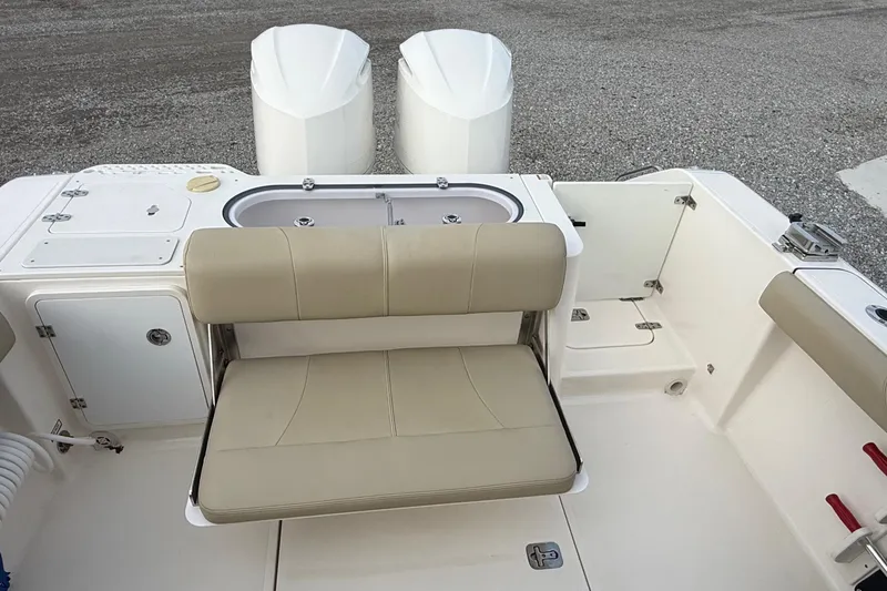 Slide: The Image of 2016 Pursuit S 280 Sport boat interior with beige seating and dual engines. - 17