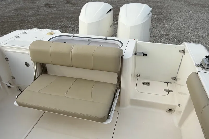 Slide: The Image of 2016 Pursuit S 280 Sport boat with beige seating and dual engines. - 18