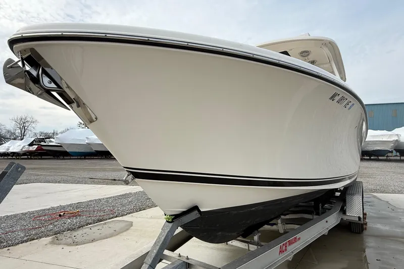 Slide: The Image of 2016 Pursuit S 280 Sport boat on trailer, side view, outdoors. - 2
