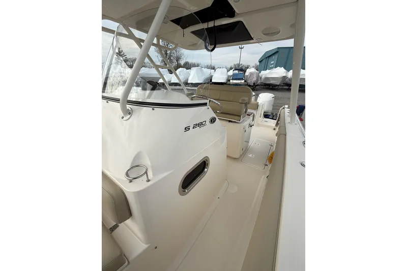 Slide: The Image of 2016 Pursuit S 280 Sport boat interior, showcasing helm and seating area. - 24