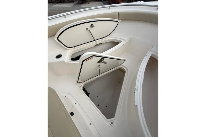 Slide: The Image of 2016 Pursuit S 280 Sport boat storage compartments open on deck. - 28