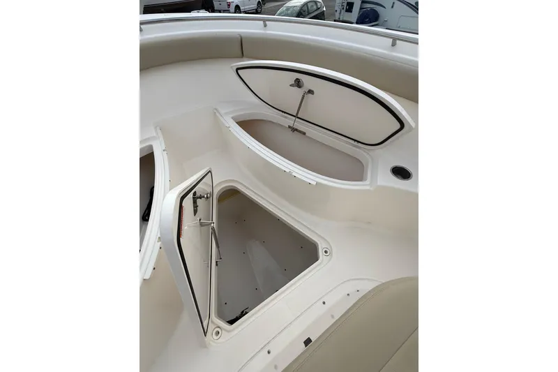Slide: The Image of 2016 Pursuit S 280 Sport boat storage compartments open on deck. - 29