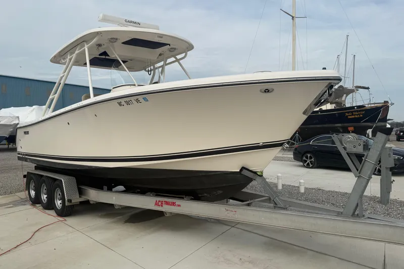 Slide: The Image of 2016 Pursuit S 280 Sport boat on trailer in marina setting. - 3