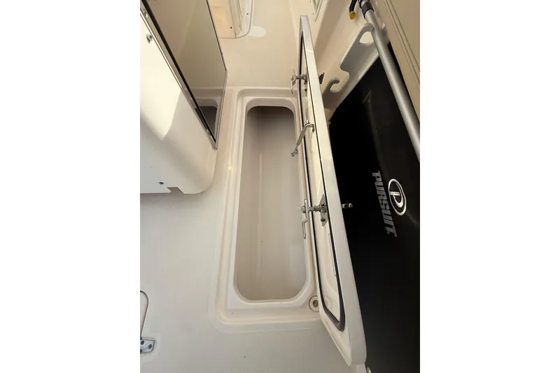 Slide: The Image of 2016 Pursuit S 280 Sport boat storage compartment with open hatch. - 31