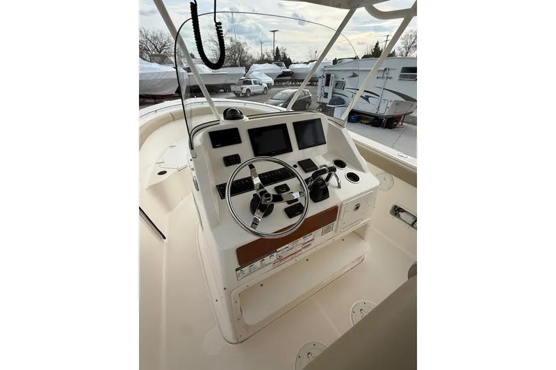 Slide: The Image of 2016 Pursuit S 280 Sport boat helm with steering wheel and navigation controls. - 32