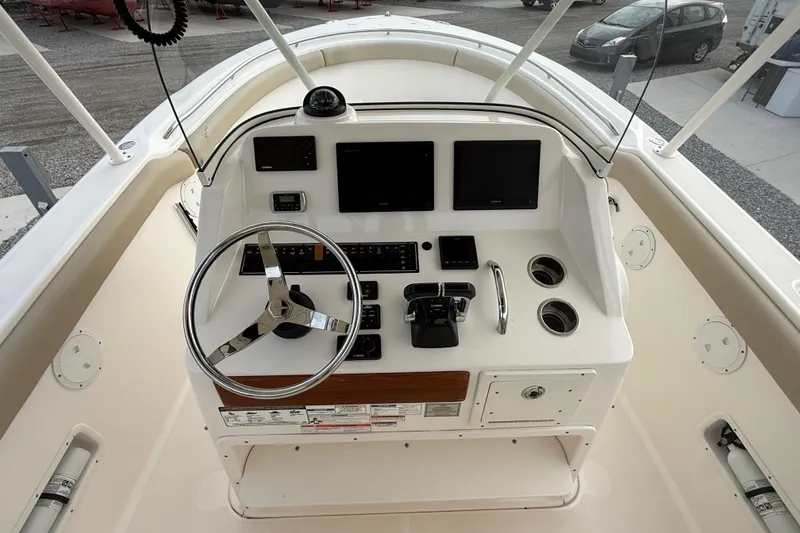 Slide: The Image of 2016 Pursuit S 280 Sport boat helm with steering wheel and navigation controls. - 33