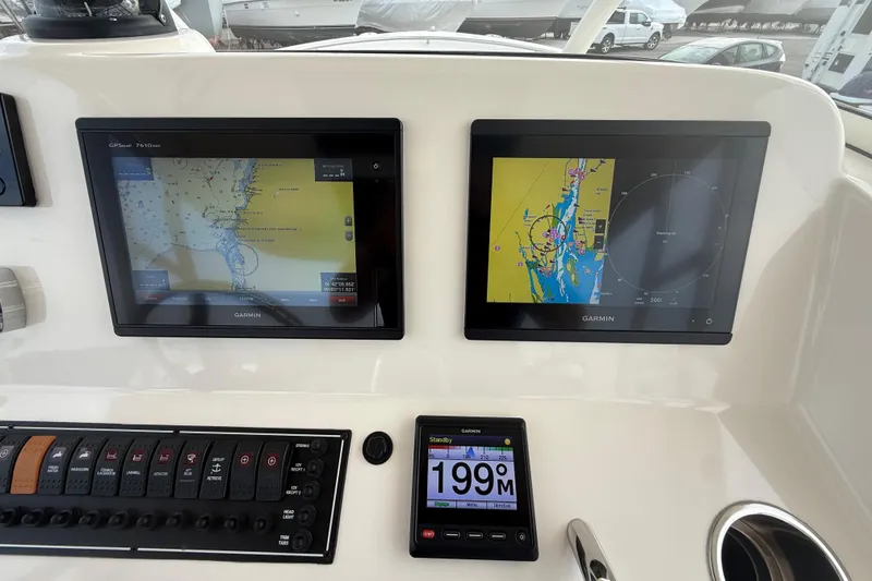 Slide: The Image of Dashboard of 2016 Pursuit S 280 Sport with Garmin navigation displays. - 35