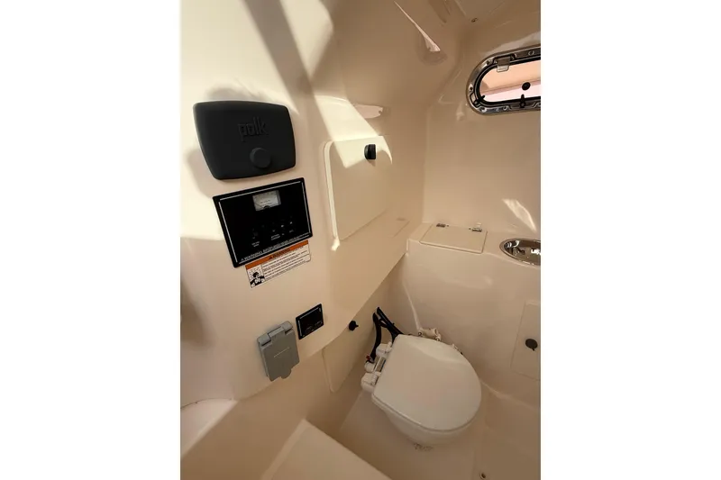 Slide: The Image of Interior of 2016 Pursuit S 280 Sport boat featuring a compact marine toilet. - 39