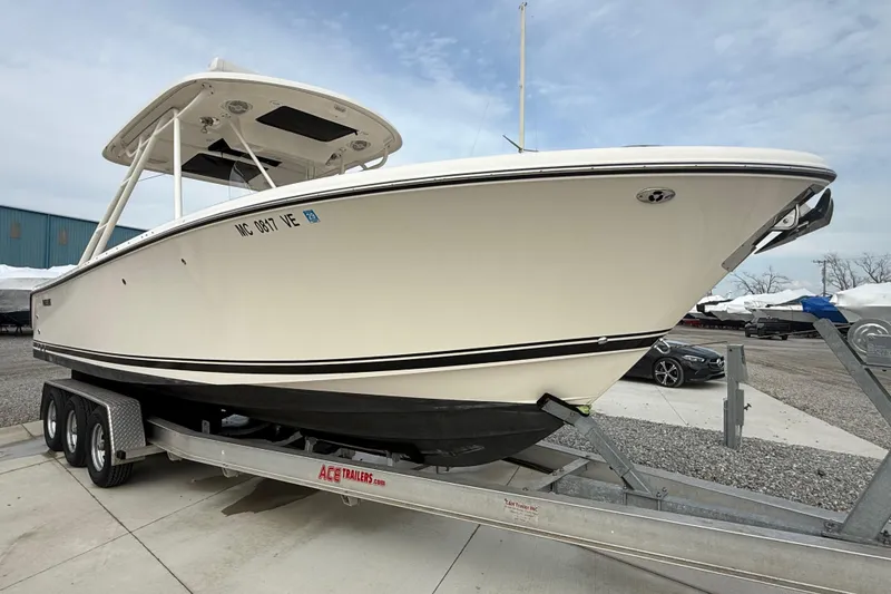 Slide: The Image of 2016 Pursuit S 280 Sport boat on trailer, parked outdoors. - 4