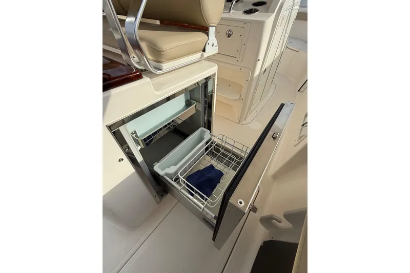 Slide: The Image of 2016 Pursuit S 280 Sport boat interior with open storage compartment and seating. - 41