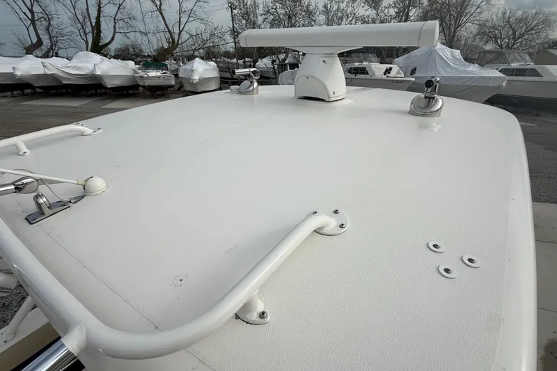 Slide: The Image of 2016 Pursuit S 280 Sport boat deck with radar and fixtures, surrounded by covered boats. - 46