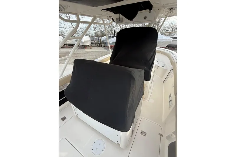 Slide: The Image of 2016 Pursuit S 280 Sport boat interior with covered seats and helm station. - 47