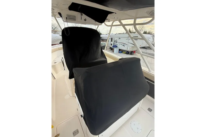 Slide: The Image of 2016 Pursuit S 280 Sport boat interior with covered seats and helm station. - 48
