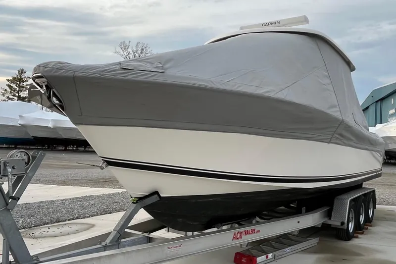 Slide: The Image of 2016 Pursuit S 280 Sport boat covered on trailer, ready for transport. - 49