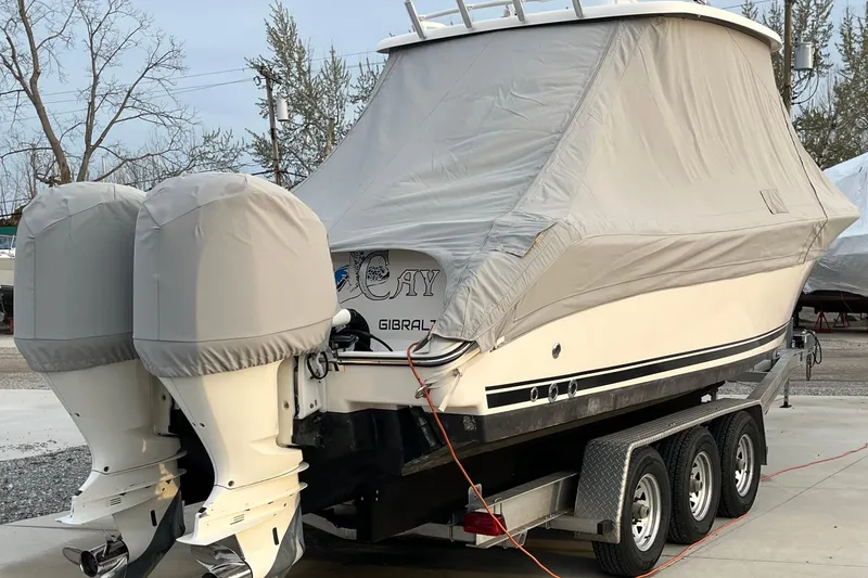 Slide: The Image of 2016 Pursuit S 280 Sport boat covered on trailer with dual engines. - 51