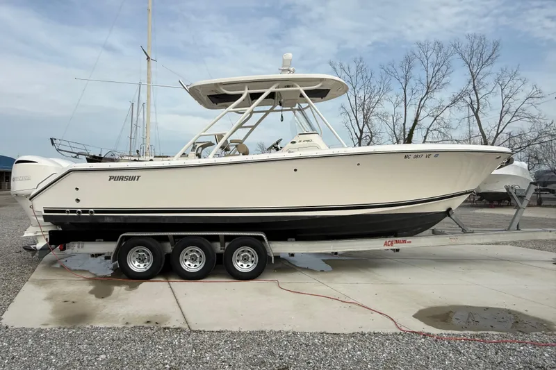 Slide: The Image of 2016 Pursuit S 280 Sport boat on trailer, parked outdoors on concrete. - 6