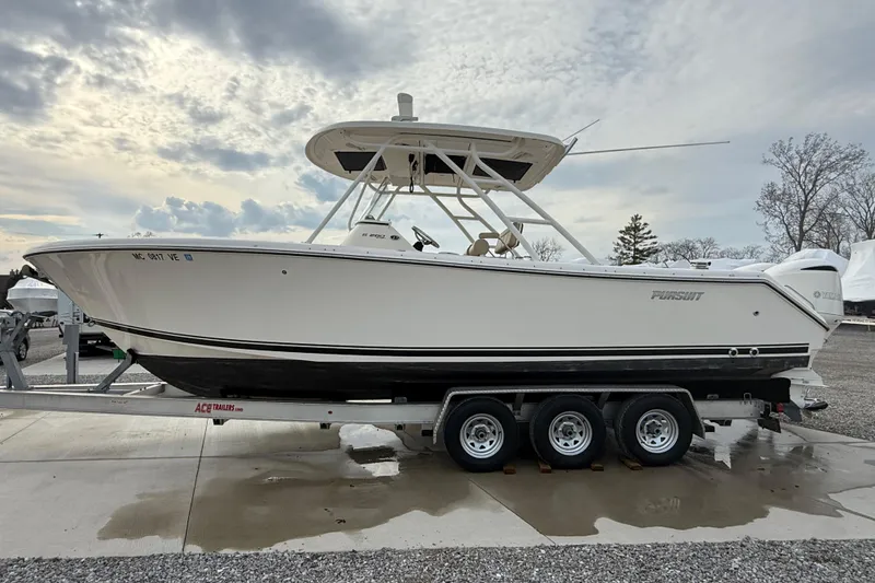 Slide: The Image of 2016 Pursuit S 280 Sport boat on trailer under cloudy sky. - 7