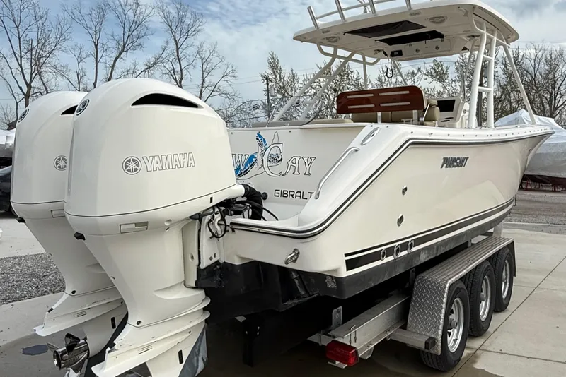 Slide: The Image of 2016 Pursuit S 280 Sport boat with twin Yamaha engines on a trailer. - 9