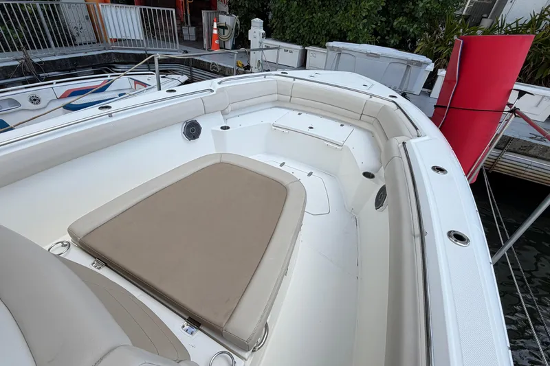 Slide: The Image of 2016 Boston Whaler 330 Outrage boat interior with cushioned seating and sleek design. - 11