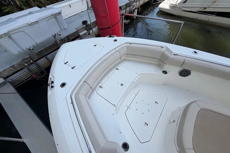 Slide: The Image of 2016 Boston Whaler 330 Outrage boat bow area with seating and storage compartments. - 12