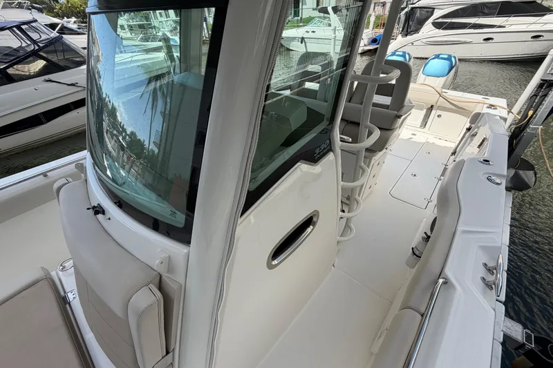 Slide: The Image of 2016 Boston Whaler 330 Outrage boat interior, featuring seating and helm station. - 13