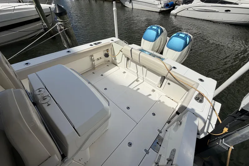 Slide: The Image of 2016 Boston Whaler 330 Outrage boat deck with twin outboard engines at marina. - 15