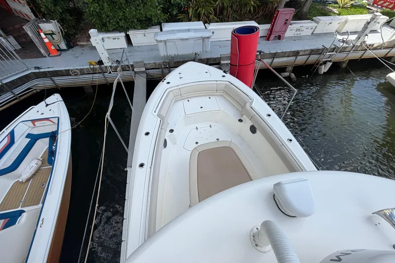 Slide: The Image of 2016 Boston Whaler 330 Outrage docked, aerial view of spacious deck and seating area. - 22