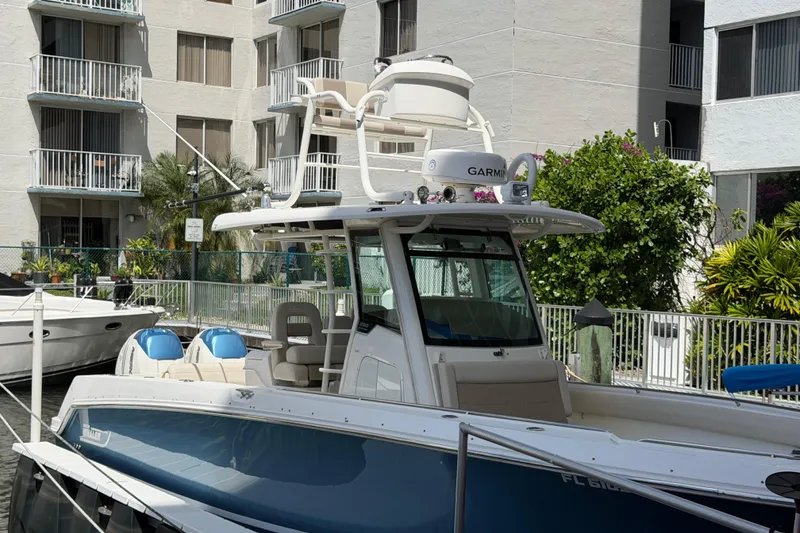 Slide: The Image of 2016 Boston Whaler 330 Outrage docked near residential buildings. - 25