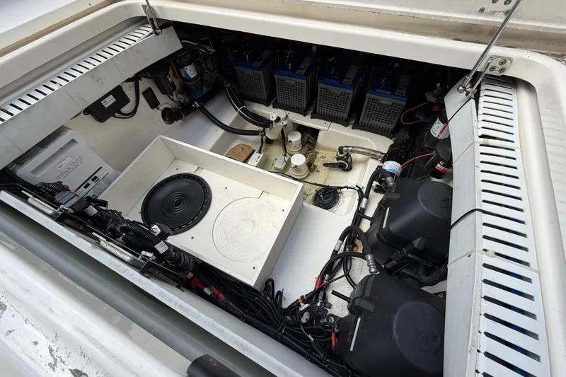 Slide: The Image of 2016 Boston Whaler 330 Outrage engine compartment with batteries and wiring. - 27